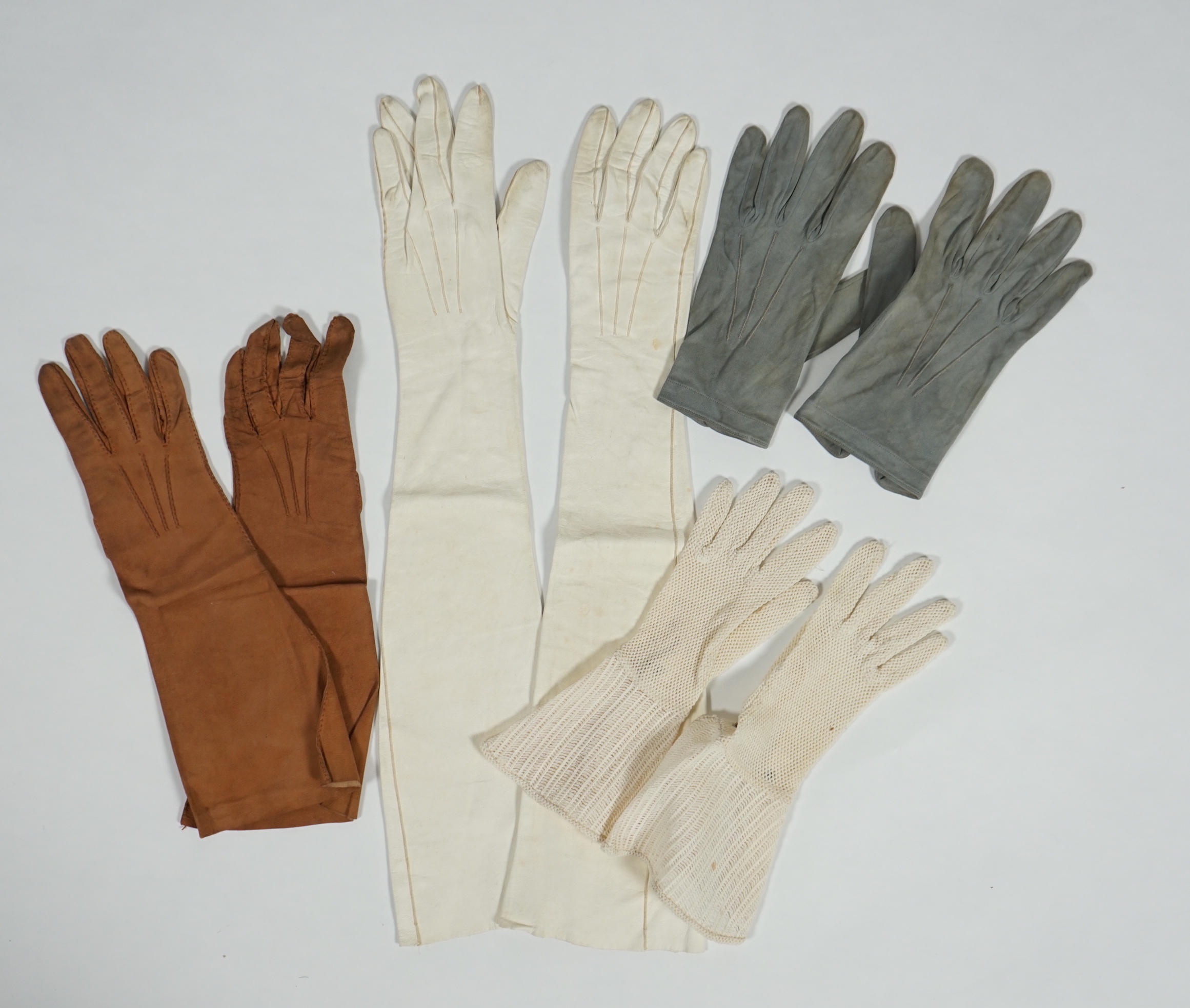 A pair of lady's Hermès skin gloves, boxed and three other pairs of gloves